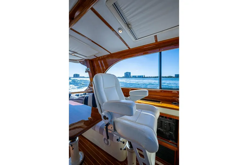 Skylark Yacht Photos Pics Interior of 2008 Hinckley Talaria 44 MY yacht with white captain's chair and ocean view.