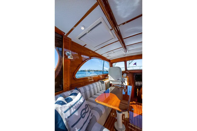 Skylark Yacht Photos Pics Luxurious interior of 2008 Hinckley Talaria 44 MY yacht with polished wood and striped seating.