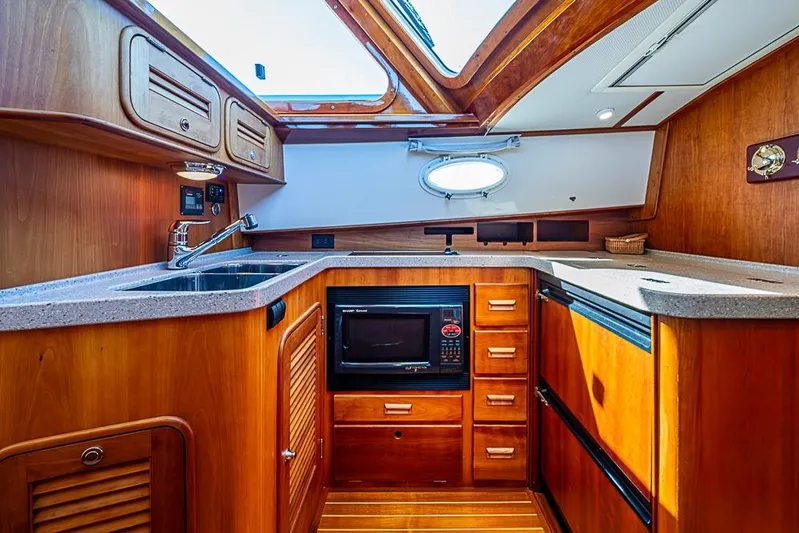 Skylark Yacht Photos Pics Luxurious 2008 Hinckley Talaria 44 MY yacht kitchen with wood cabinetry and modern appliances.