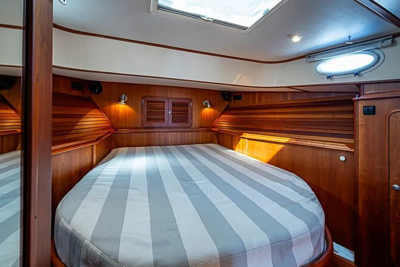 Skylark Yacht Photos Pics Luxurious cabin interior of 2008 Hinckley Talaria 44 MY yacht with striped bedding.