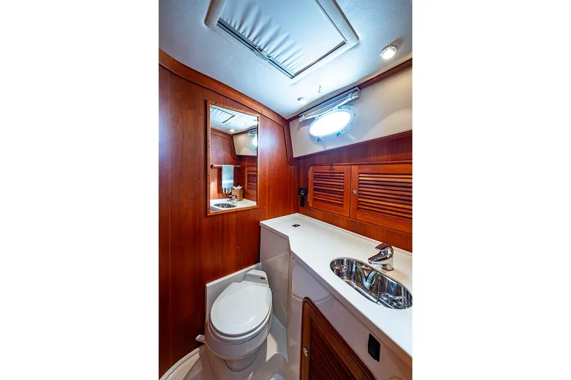 Skylark Yacht Photos Pics Luxurious 2008 Hinckley Talaria 44 MY yacht bathroom with wood paneling and modern fixtures.