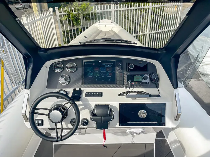  Yacht Photos Pics 2025 Ribco Venom 30 boat dashboard with steering wheel, gauges, and navigation controls.