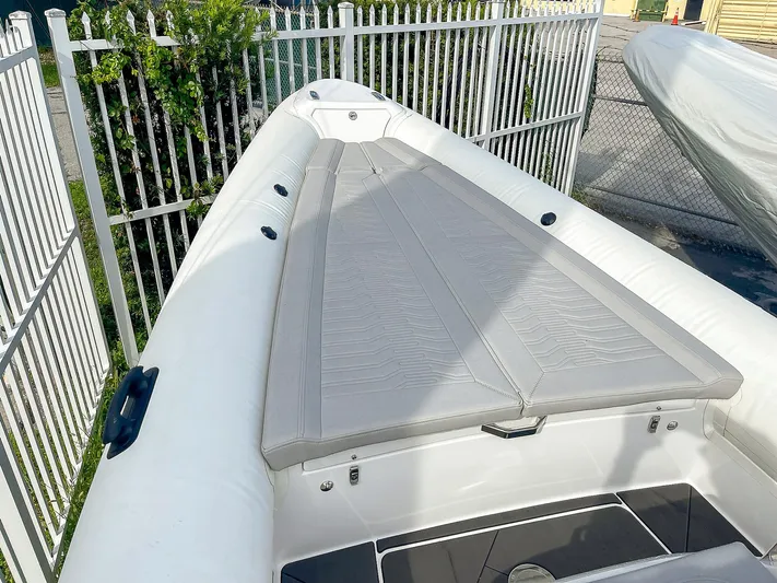  Yacht Photos Pics 2025 Ribco Venom 30 boat with sleek white deck and cushioned seating.