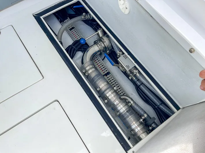  Yacht Photos Pics Engine compartment of 2025 Ribco Venom 30 boat, showcasing mechanical components and hoses.