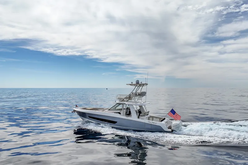 Fan Tail III Yacht Photos Pics 2018 Boston Whaler 420 Outrage cruising on open sea under a cloudy sky.