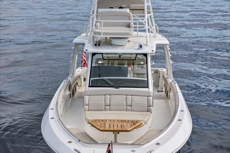 Fan Tail III Yacht Photos Pics 2018 Boston Whaler 420 Outrage boat on calm water, showcasing luxury seating and design.