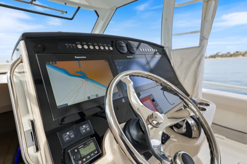Fan Tail III Yacht Photos Pics 2018 Boston Whaler 420 Outrage helm with navigation display and steering wheel.