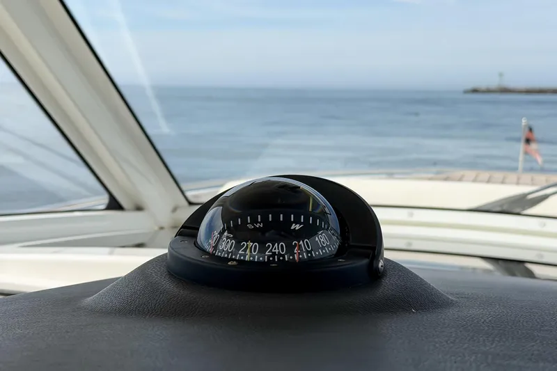 Fan Tail III Yacht Photos Pics Compass on 2018 Boston Whaler 420 Outrage, overlooking calm ocean waters.