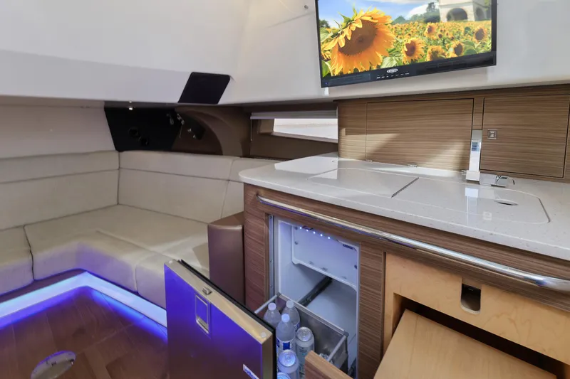 Fan Tail III Yacht Photos Pics Luxurious interior of 2018 Boston Whaler 420 Outrage with seating, kitchenette, and TV.