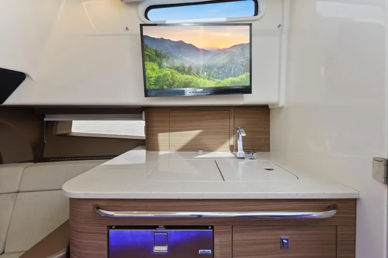 Fan Tail III Yacht Photos Pics Interior of 2018 Boston Whaler 420 Outrage with modern kitchenette and mounted TV.