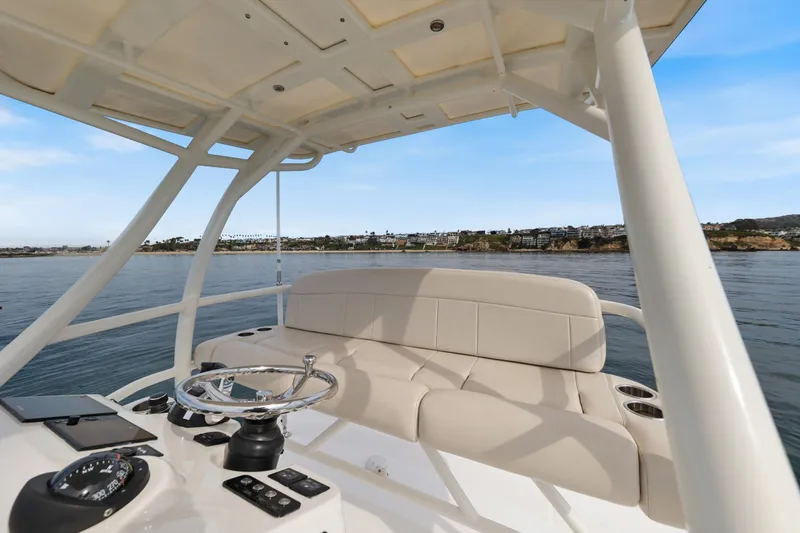 Fan Tail III Yacht Photos Pics 2018 Boston Whaler 420 Outrage helm with seating, overlooking serene coastal waters.