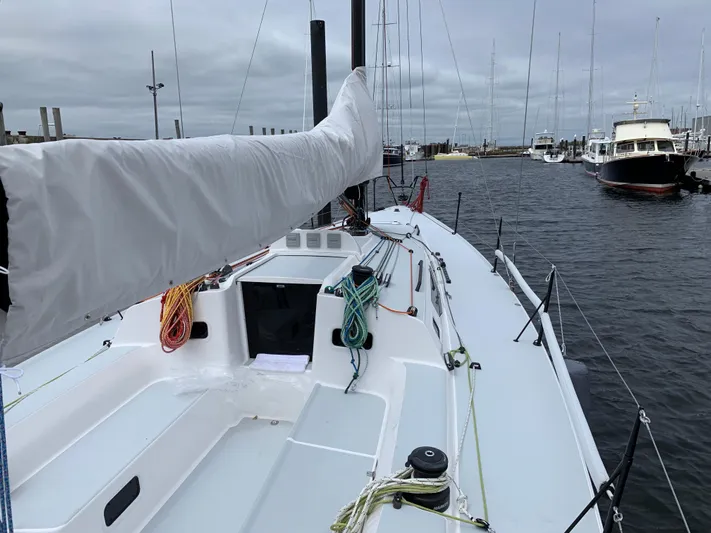 Ace Yacht Photos Pics 2019 J Boats J/121 sailboat docked in a marina, featuring a sleek deck design.