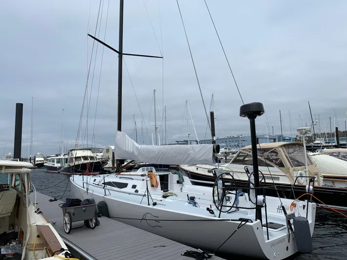 Ace Yacht Photos Pics 2019 J Boats J/121 sailboat docked at marina, overcast sky.