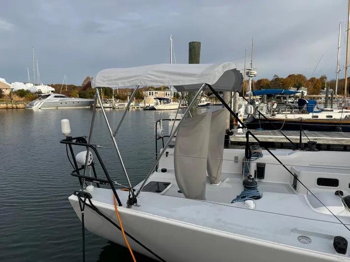 Ace Yacht Photos Pics 2019 J Boats J/121 sailboat docked at a marina with a canopy.
