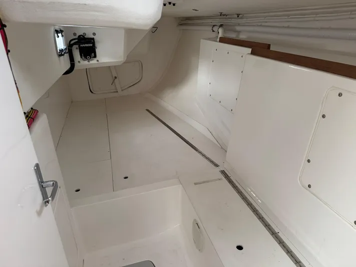 Ace Yacht Photos Pics Interior of 2019 J Boats J/121 sailboat, featuring spacious white cabin layout.