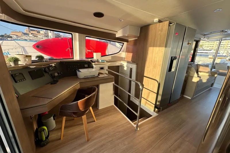 Platinum Yacht Photos Pics Modern interior of 2023 Bali 4.6 yacht with navigation desk and seating area.