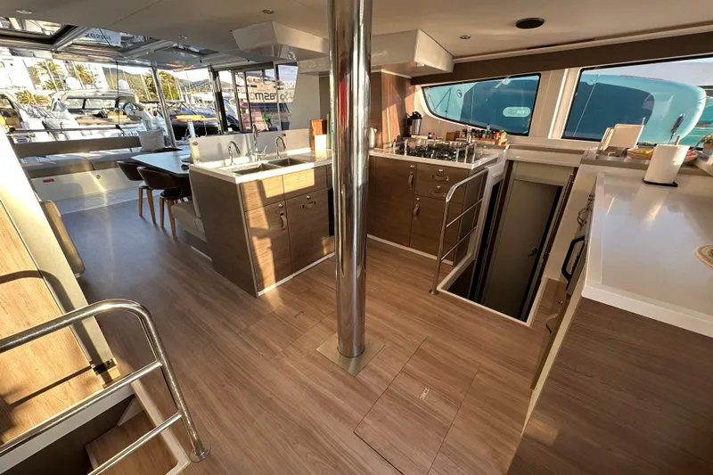Platinum Yacht Photos Pics Modern 2023 Bali 4.6 yacht interior with kitchen, dining area, and sleek wood finishes.