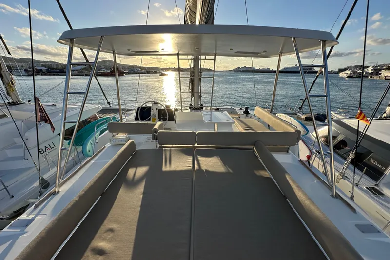 Platinum Yacht Photos Pics 2023 Bali 4.6 yacht deck at sunset, featuring spacious seating and ocean view.