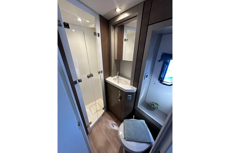 Platinum Yacht Photos Pics Modern bathroom in 2023 Bali 4.6 model yacht with shower, sink, and window.