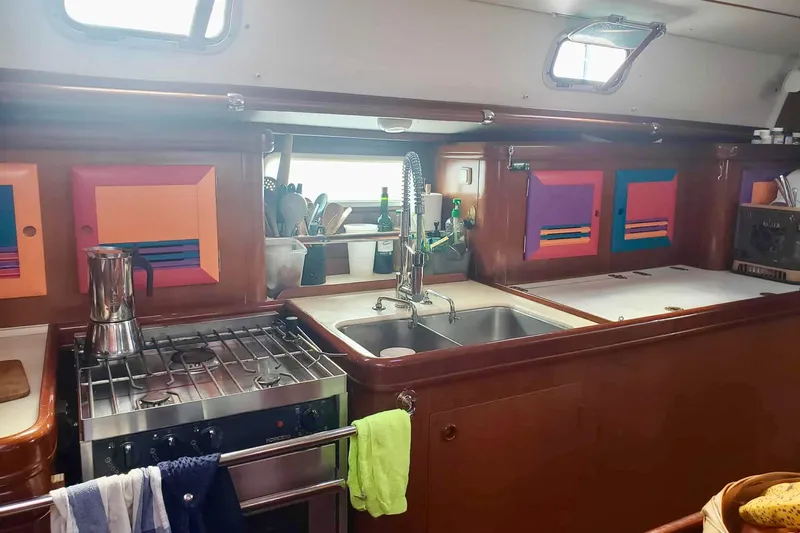 Lady Vague Yacht Photos Pics 2001 Beneteau 50 yacht kitchen with colorful cabinets and modern appliances.