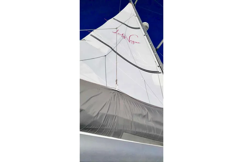 Lady Vague Yacht Photos Pics Sail of a 2001 Beneteau 50 yacht against a clear blue sky.