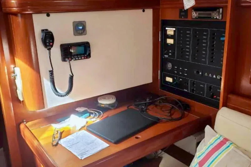 Lady Vague Yacht Photos Pics Navigation station on a 2001 Beneteau 50 yacht with communication equipment and control panel.