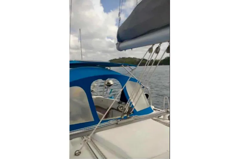 Lady Vague Yacht Photos Pics 2001 Beneteau 50 sailboat with blue canopy on calm water.