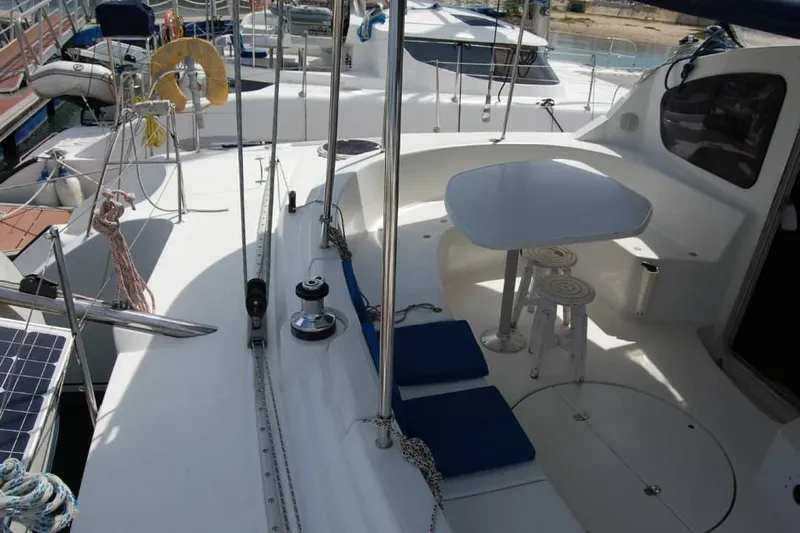  Yacht Photos Pics 2006 Fountaine Pajot Belize 43 catamaran deck with seating and table, docked at marina.