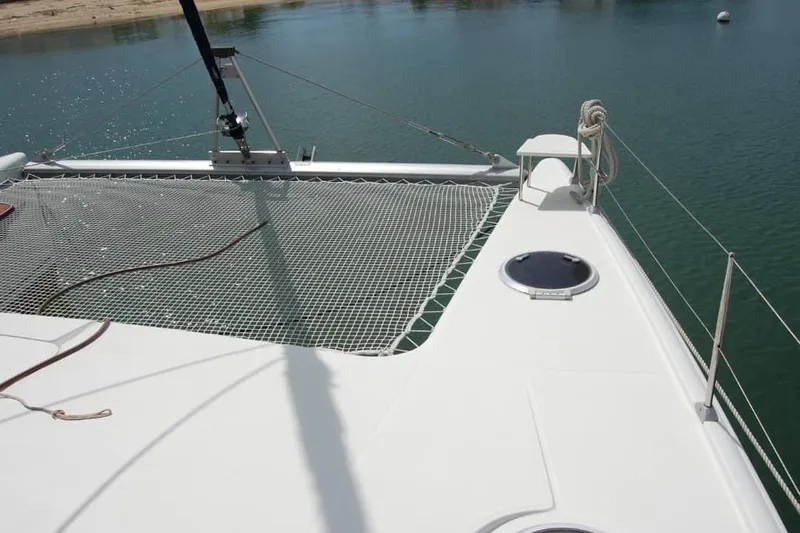  Yacht Photos Pics 2006 Fountaine Pajot Belize 43 catamaran deck with netting over calm water.