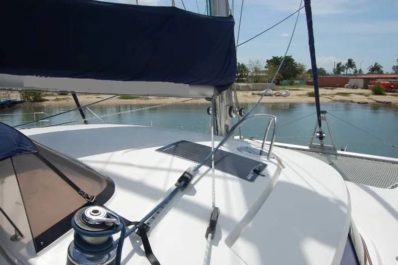  Yacht Photos Pics 2006 Fountaine Pajot Belize 43 catamaran deck with winch and sail, docked by the shore.