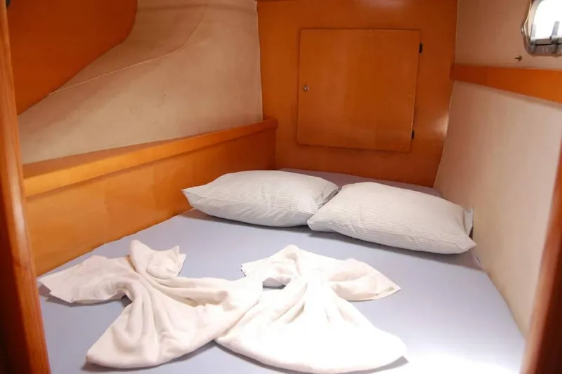  Yacht Photos Pics Cozy cabin interior of 2006 Fountaine Pajot Belize 43 with neatly arranged bed and pillows.