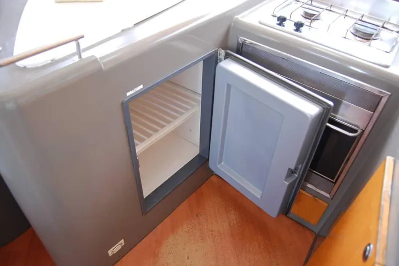  Yacht Photos Pics Galley kitchen in 2006 Fountaine Pajot Belize 43, featuring open fridge and stove.