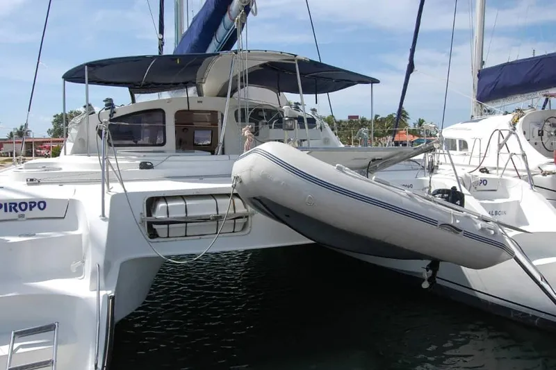  Yacht Photos Pics 2006 Fountaine Pajot Belize 43 catamaran with dinghy, docked in a marina.