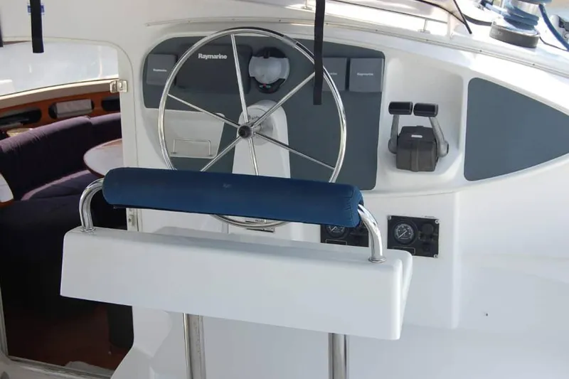  Yacht Photos Pics Helm of 2006 Fountaine Pajot Belize 43 catamaran with steering wheel and navigation controls.