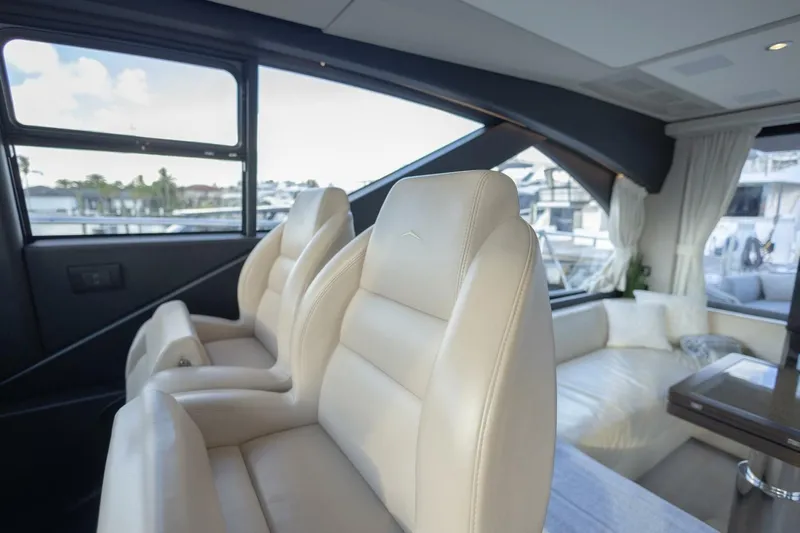Asymmetry Yacht Photos Pics Luxurious interior of 2023 Azimut S6 Sport-Fly yacht with plush seating and panoramic windows.