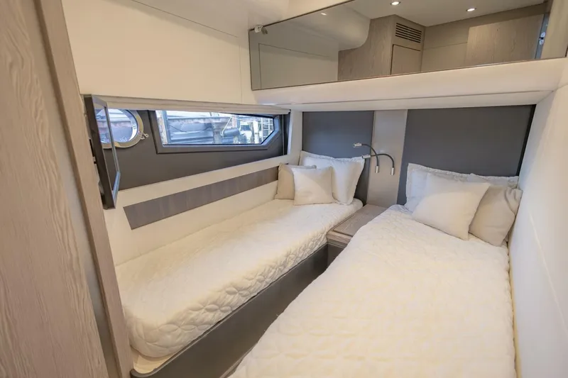 Asymmetry Yacht Photos Pics Luxurious twin cabin in 2023 Azimut S6 Sport-Fly yacht, featuring modern design and cozy bedding.
