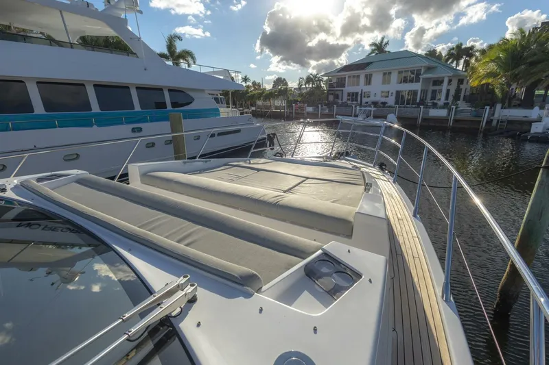 Asymmetry Yacht Photos Pics 2023 Azimut S6 Sport-Fly yacht with sun deck, docked near waterfront property.