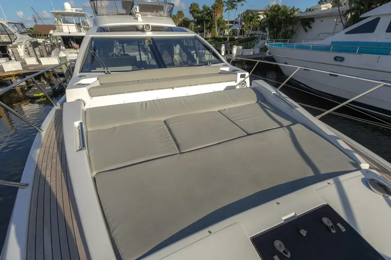 Asymmetry Yacht Photos Pics 2023 Azimut S6 Sport-Fly yacht with spacious sunbathing area, docked at marina.