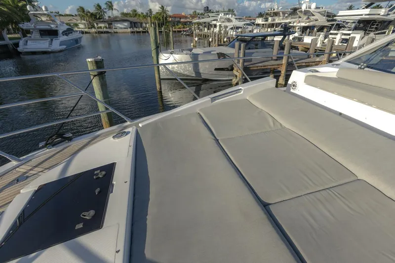 Asymmetry Yacht Photos Pics 2023 Azimut S6 Sport-Fly yacht with spacious deck and luxurious seating at marina.