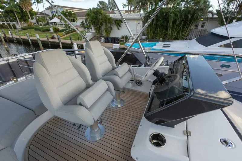 Asymmetry Yacht Photos Pics 2023 Azimut S6 Sport-Fly yacht helm with dual seats and sleek dashboard.