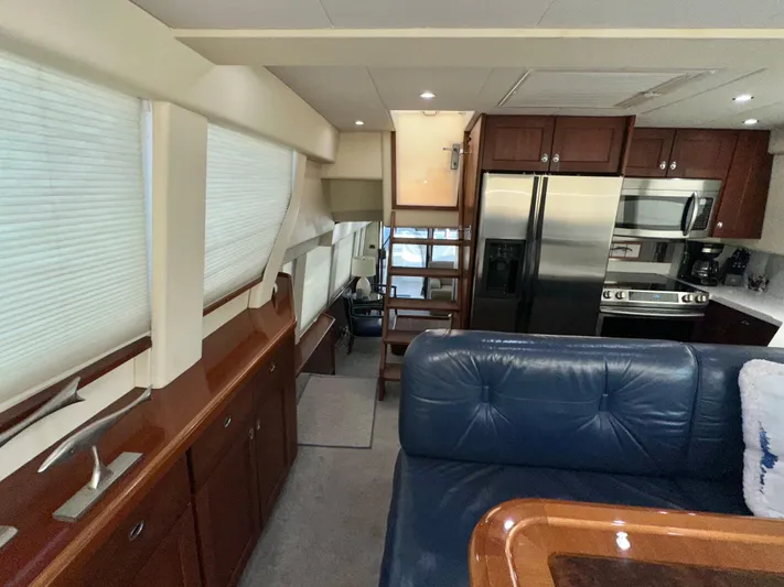 Odds Are Yacht Photos Pics Interior of 2003 Pacific Mariner 65 SE Motoryacht with modern kitchen and seating area.