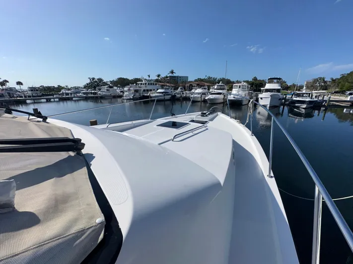 Odds Are Yacht Photos Pics 2003 Pacific Mariner 65 SE Motoryacht docked in a sunny marina.