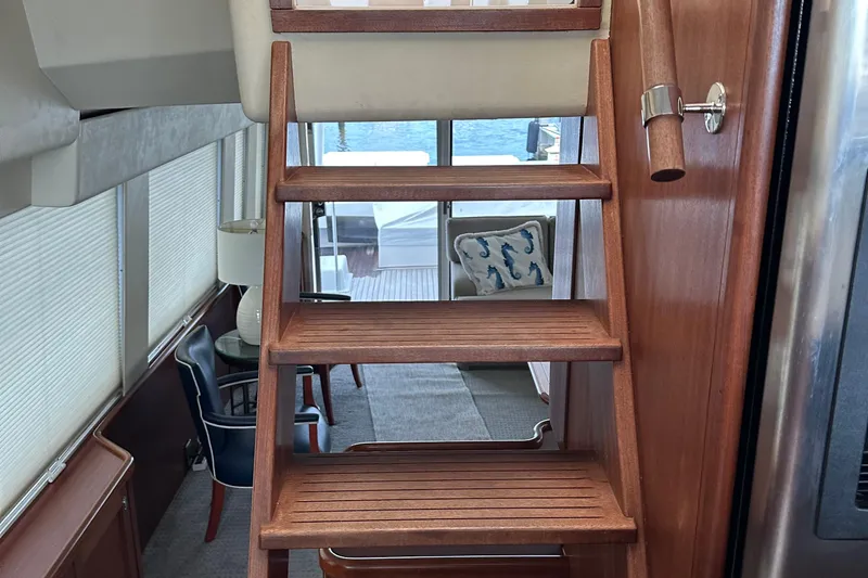 Odds Are Yacht Photos Pics Interior of 2003 Pacific Mariner 65 SE Motoryacht with wooden stairs and elegant decor.
