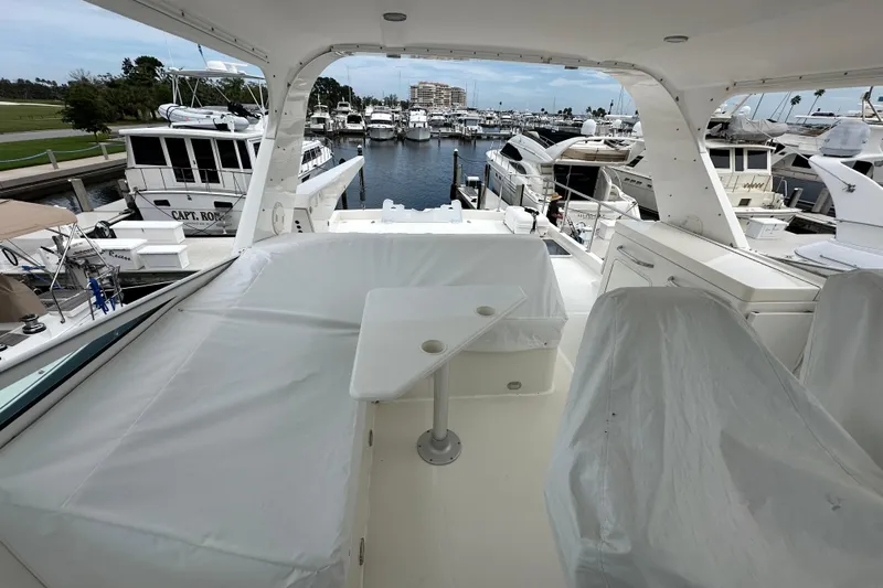 Odds Are Yacht Photos Pics 2003 Pacific Mariner 65 SE Motoryacht docked at marina, featuring covered seating area.