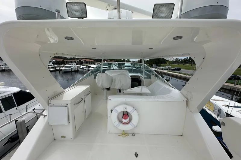 Odds Are Yacht Photos Pics 2003 Pacific Mariner 65 SE Motoryacht deck with marina view and safety equipment.