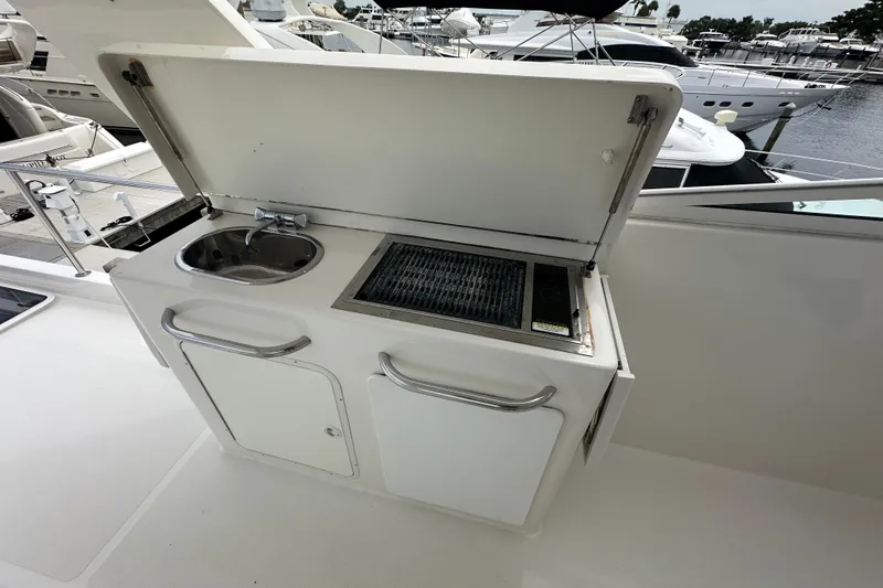 Odds Are Yacht Photos Pics Outdoor kitchenette on 2003 Pacific Mariner 65 SE Motoryacht with sink and grill.