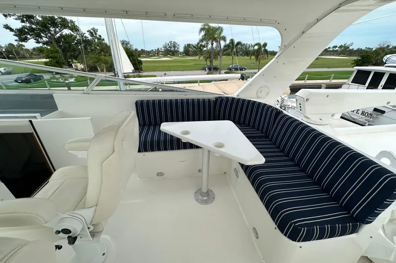 Odds Are Yacht Photos Pics 2003 Pacific Mariner 65 SE Motoryacht with striped seating and table on deck.