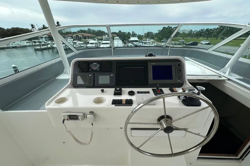 Odds Are Yacht Photos Pics Helm of 2003 Pacific Mariner 65 SE Motoryacht with navigation equipment and steering wheel.