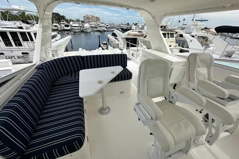 Odds Are Yacht Photos Pics 2003 Pacific Mariner 65 SE Motoryacht interior with striped seating and helm chairs in marina.