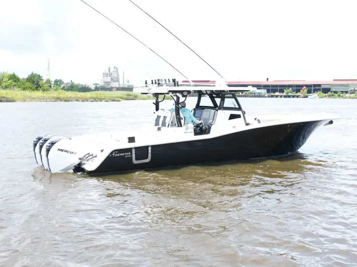  Yacht Photos Pics 2023 Tidewater 380 CC Adventure boat on water, featuring triple Mercury engines.